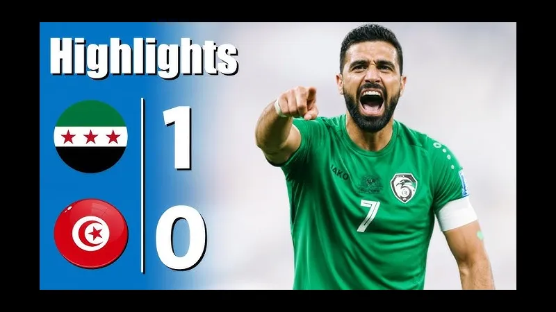 Cầu thủ Palestine với áo đỏ đang dốc hết sức mình để cản phá cầu thủ Tunisia với áo trắng.